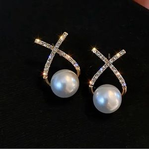 Gold colored Elegant criss cross earrings with cubic zirconia inlays